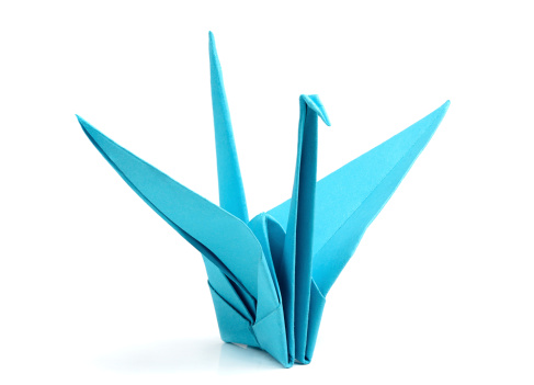 Blue origami bird isolated on white background.