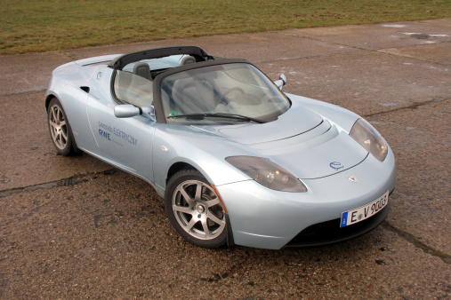 Warsaw, Poland – November 18th, 2009: Tesla Roadster stopped during the test drive. Model Roadster debuted in 2009 and it is the first model from Tesla brand. This sport electric roadster accelerates from 0 to 60 mph in 3,7 seconds.