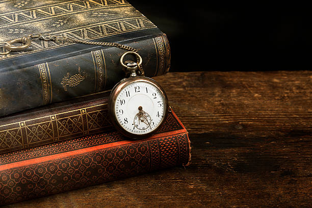 istock Old pocket watch and books with copy space 509611936