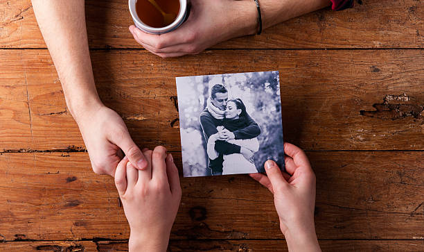 istock Unrecognizable man holding womans hand. Looking  at their photo. 509613856