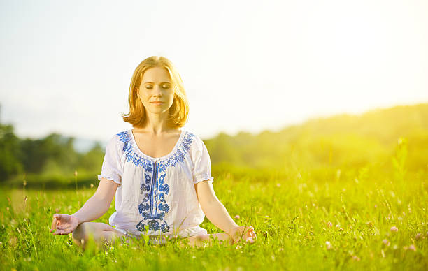 istock young woman doing yoga on green grass 509613935