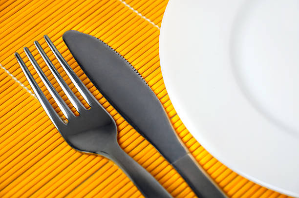 Empty plate and utensils stock photo