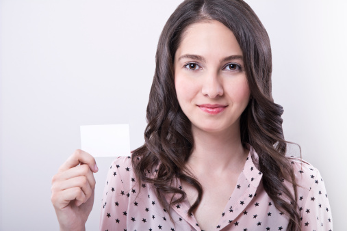 beautiful woman holding blank card