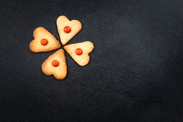 istock Heart shape cookies on black stone background 509614282