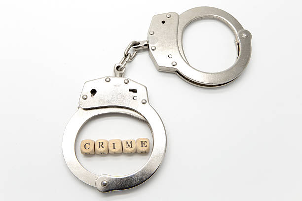 istock Handcuffs with word crime on wooden cubes 509615480