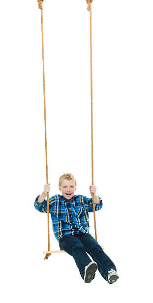 istock Smiling little boy swinging 509616066