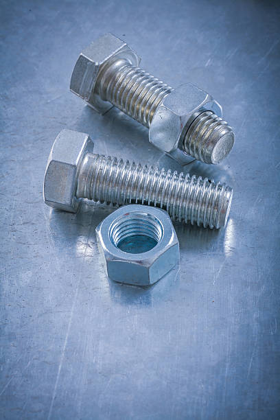 istock Stainless threaded bolts screw-nuts on metallic background maint 509616882
