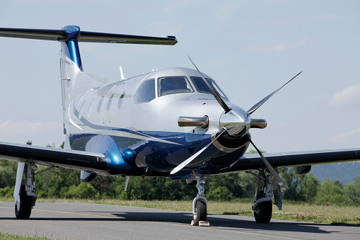 Single BLUE turboprop aircraft parked on runway.