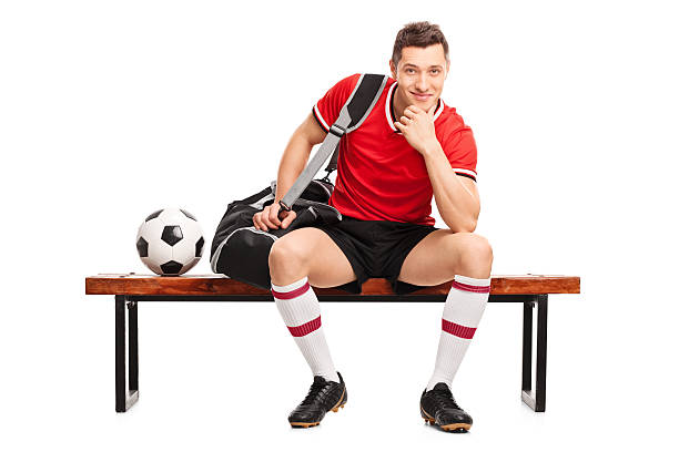 istock Young football player sitting on a bench 509619064