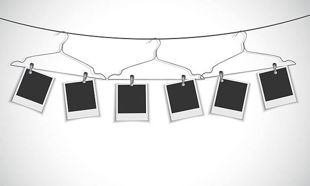 Blank photo frame hanging on a rope with clothes hanger Vector EPS 10 format. coathanger photos stock illustrations