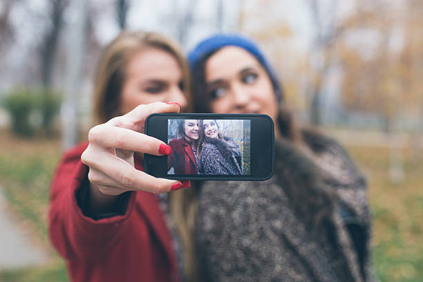 istock Smiling girls taking a selfie with smartphone 509621626