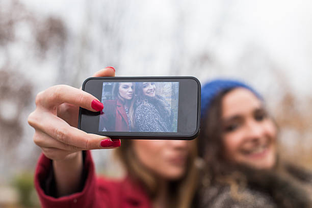 istock Smiling girls taking a selfie with smartphone 509621676