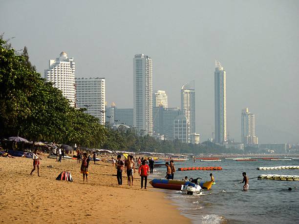 Jomtien, Thailand - January 4, 2016: Tourists and locals walking on Jomtien Beach, a popular resort on the gulf of Thailand