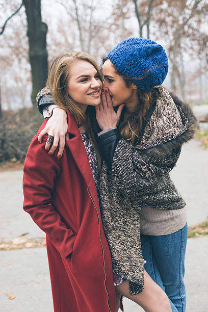 istock Two women flirting in park 509622226