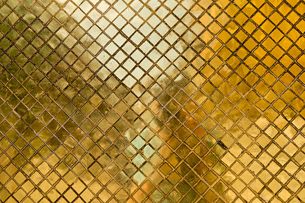 Gold tile mosaic background at an ancient Thai Buddhist temple, Bangkok, Thailand. 