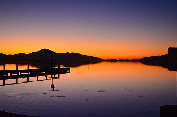 Silhouette of a pier with reflection stock photo