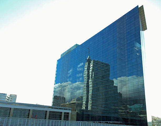 istock Glass Building reflects Puffy Clouds and Blue Skies 509624184