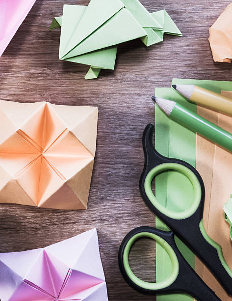 istock Origami figures on wooden table - vertical, close up. 509624304