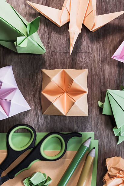 istock Origami figurines on oak table. 509624542