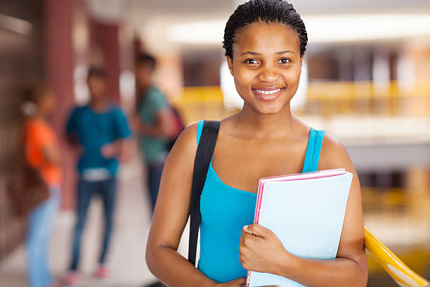 istock female african college student holding books 509624825