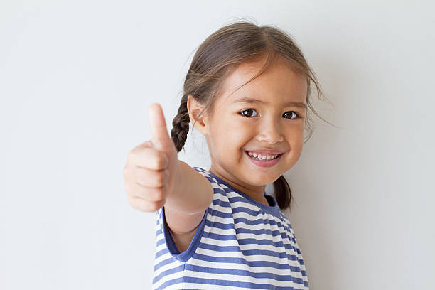girl giving thumb up hand sign