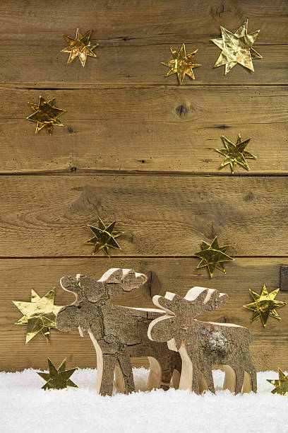 istock Two wooden elks on wooden christmas background. 509625665
