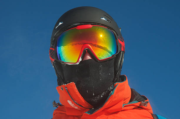 Mountain range reflected in the ski mask Winter mountain landscape and ski slope reflected in a ski mask. Selective focus. brightly lit winter season rock stock pictures, royalty-free photos & images