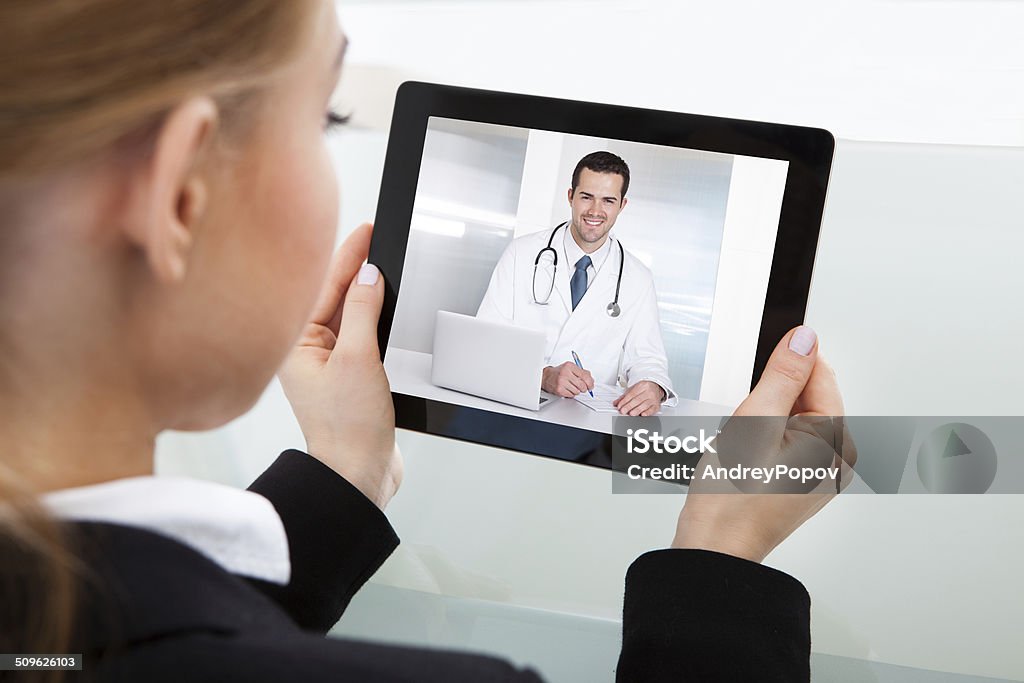 Businesswoman Having Video Chat Close-up Of Businesswoman Having A Video Chat With Doctor Doctor Stock Photo