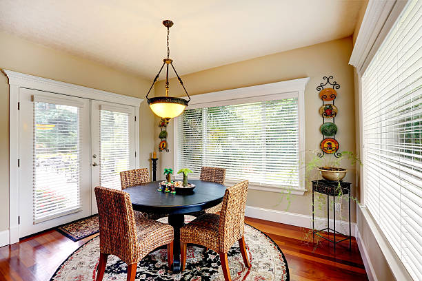 istock Dining room with round black table and wicker chairs 509626223
