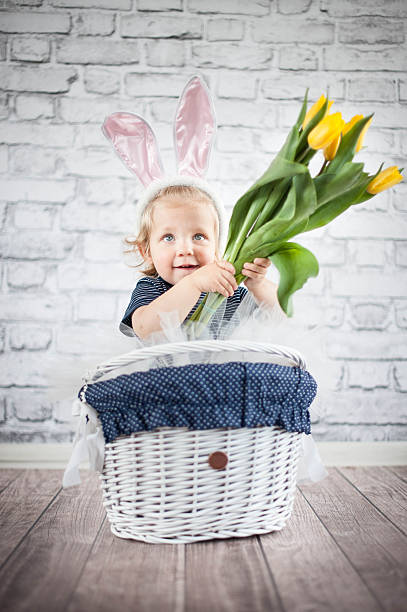 istock Cute baby bunny with yellow tulips 509626997