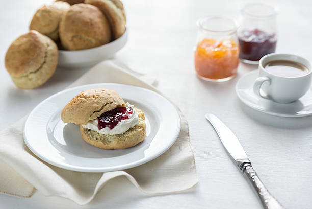 istock Scones with cream and fruit jam and cup of coffee 509627754