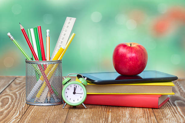 School supplies on green empty space background.