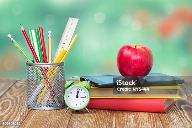 School Supplies On Green Empty Space Background Stock Photo - Download Image Now - Apple - Fruit, Book, Desk