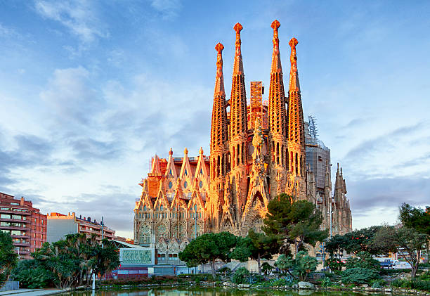 Barcelona, Spain - February 10th, 2016: Tourists at backside of famous church and cathedral Sagrada Familia in Barcelona. Seen from subway station Sagrada Familia. Church also called Temple Expiatori de la Sagrada Família - famous basilica built by Antoni Gaudi in year 1882 and til today not finished. Church is located in district Eixample in North of town. Some parts of church are UNESCO World Heritage.