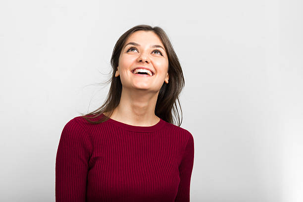 istock Beautiful young woman smiling and looking up 509628946