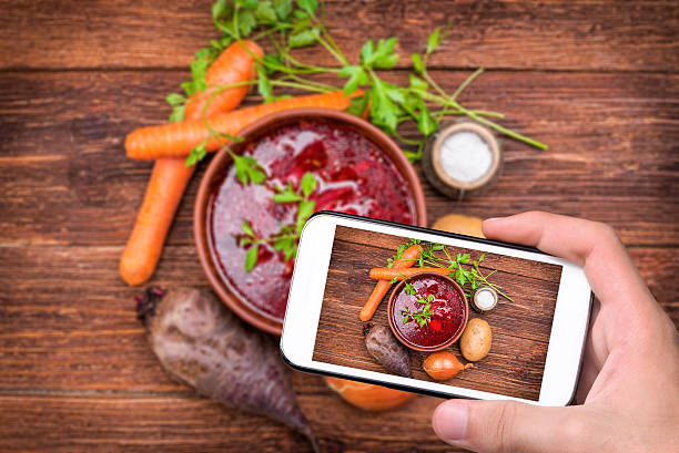 istock Hands taking photo red beetroot soup with smartphone. 509629528