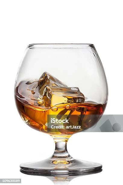 Splash Of Whiskey With Ice In Glass Isolated On White Stock Photo - Download Image Now