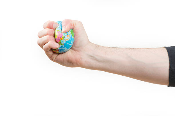 глобальное потепление - crushed human hand earth ball стоковые фото и изображения