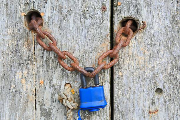 istock Padlock on an old wooden door. 509630836
