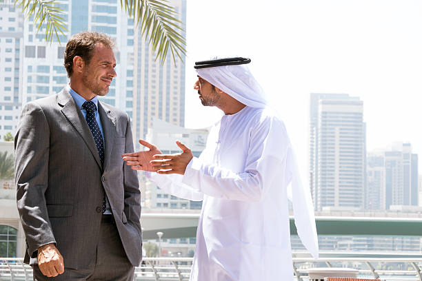 istock Middle eastern businessmen talking with western man 509633100