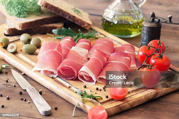 Sliced Prosciutto On A Wooden Board Stock Photo - Download Image Now - Prosciutto, Parma Ham, Parma - Italy