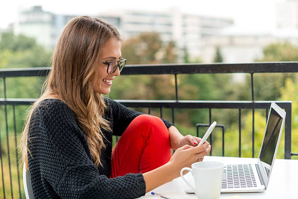 istock Smiling Young woman with mobile phone 509633450