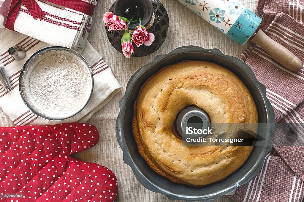 Home-Made Bundt Cake Arrangement with some utensils and ingredients for a bundt cake made at home. Directly above view Bundt Cake Stock Photo