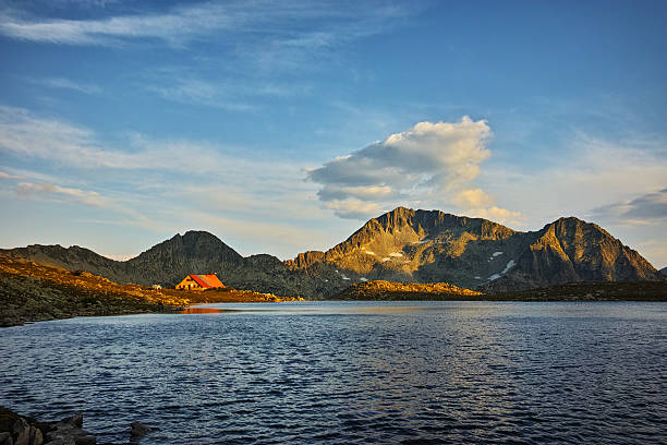 Yellow Sunset over Tevno Lake and Kamenitsa peak, Pirin mountain, Bulgaria