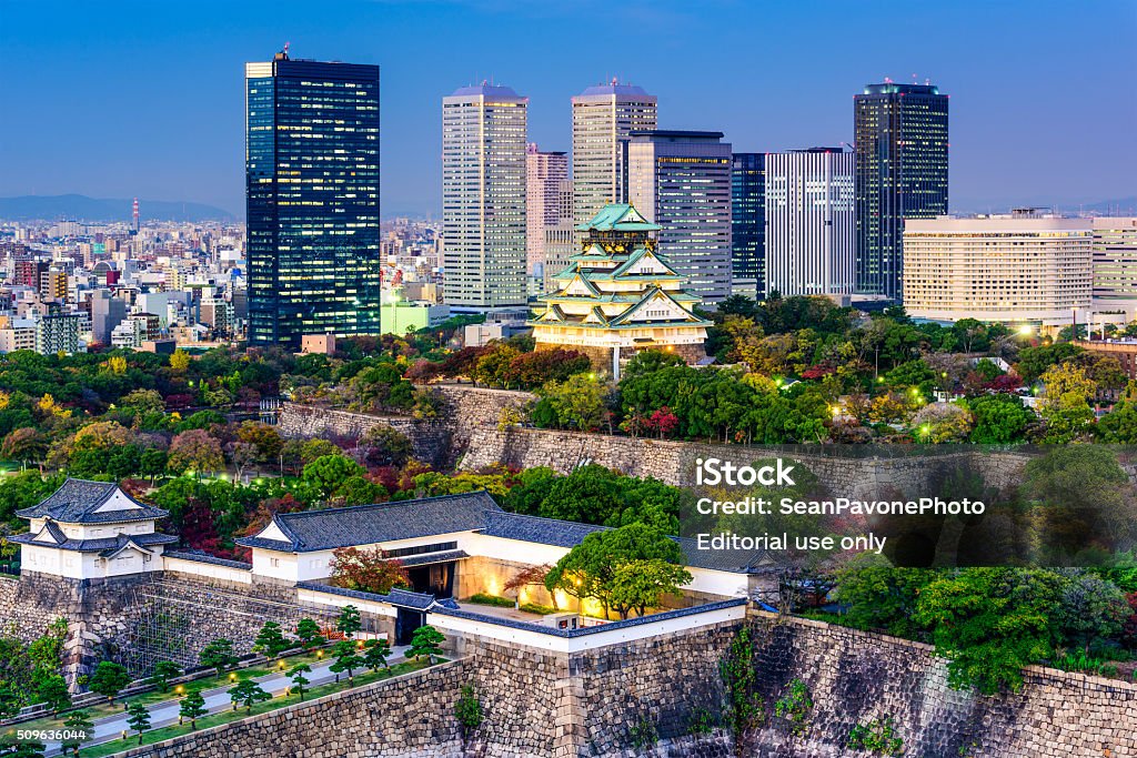 Osaka, Japan Skyline Osaka, Japan - November 20, 2015: Overlooking Osaka Castle Park at dusk. The castle dates from 1583 and the most recent reconstruction was completed in 1997. Osaka Castle Stock Photo