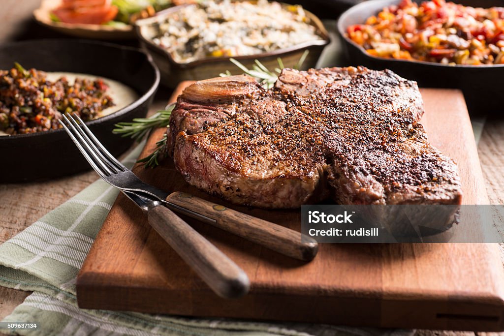 Porterhouse Steak Porterhouse Steak with Sweet Potato Casserole and Creamed Collard Greens American Culture Stock Photo