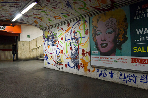 Rome, Italy - December 31, 2014: Mural  in the corridor of Rome metro station, Italy, with a person in the background