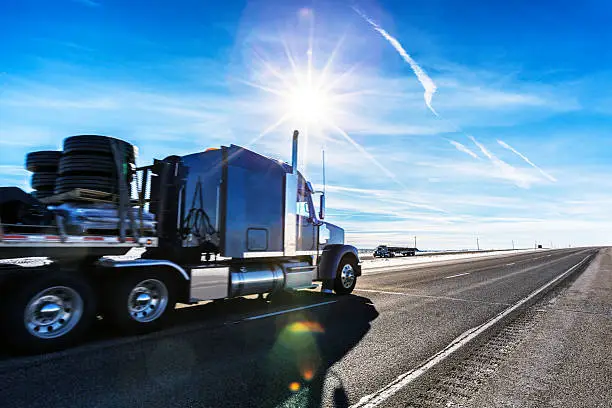 Photo of Expressway Flatbed Semi Trailer Trucks on Western USA Sunflare Highway