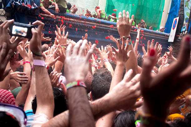 With a truck throw tomatoes into crowd on Tomatina festival stock photo
