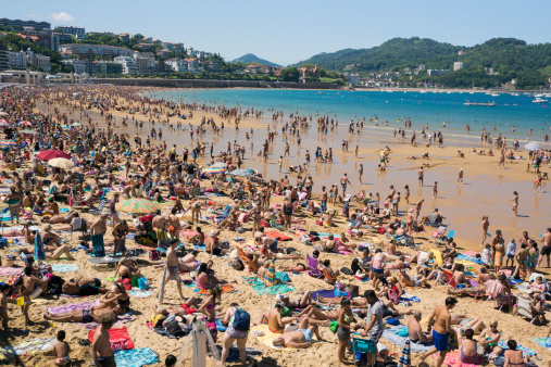 San Sebastian crowded beach in summer Spain